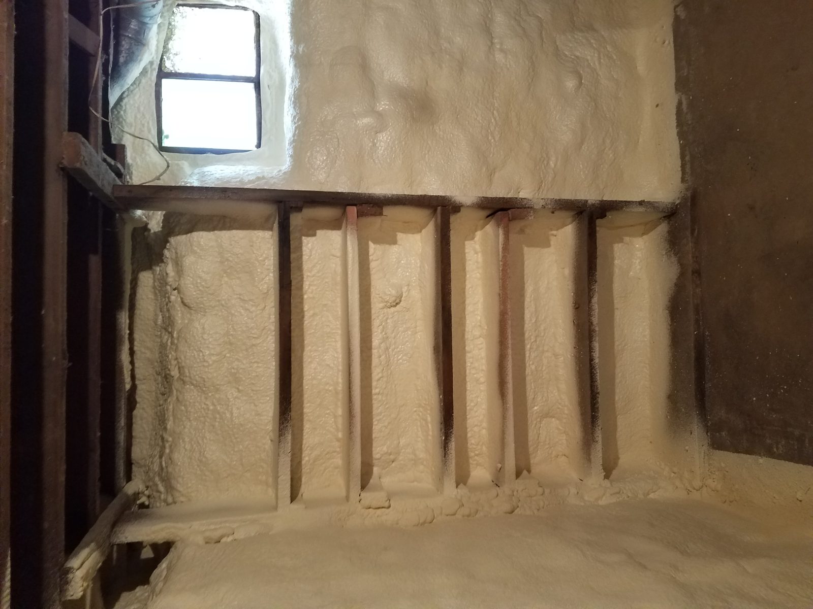 Closed-cell spray foam applied to a metal building wall