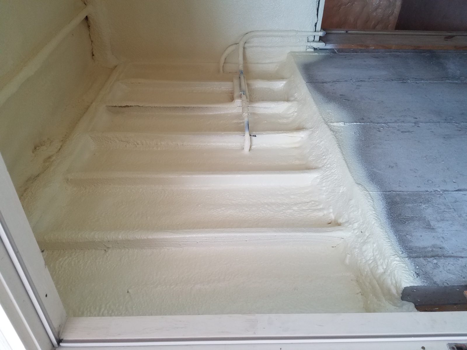 Wall cavity spray foam installation