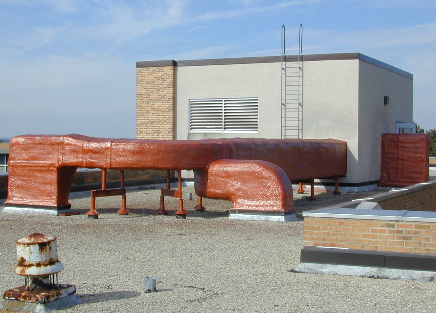 Low-slope commercial roof with foam and coating system